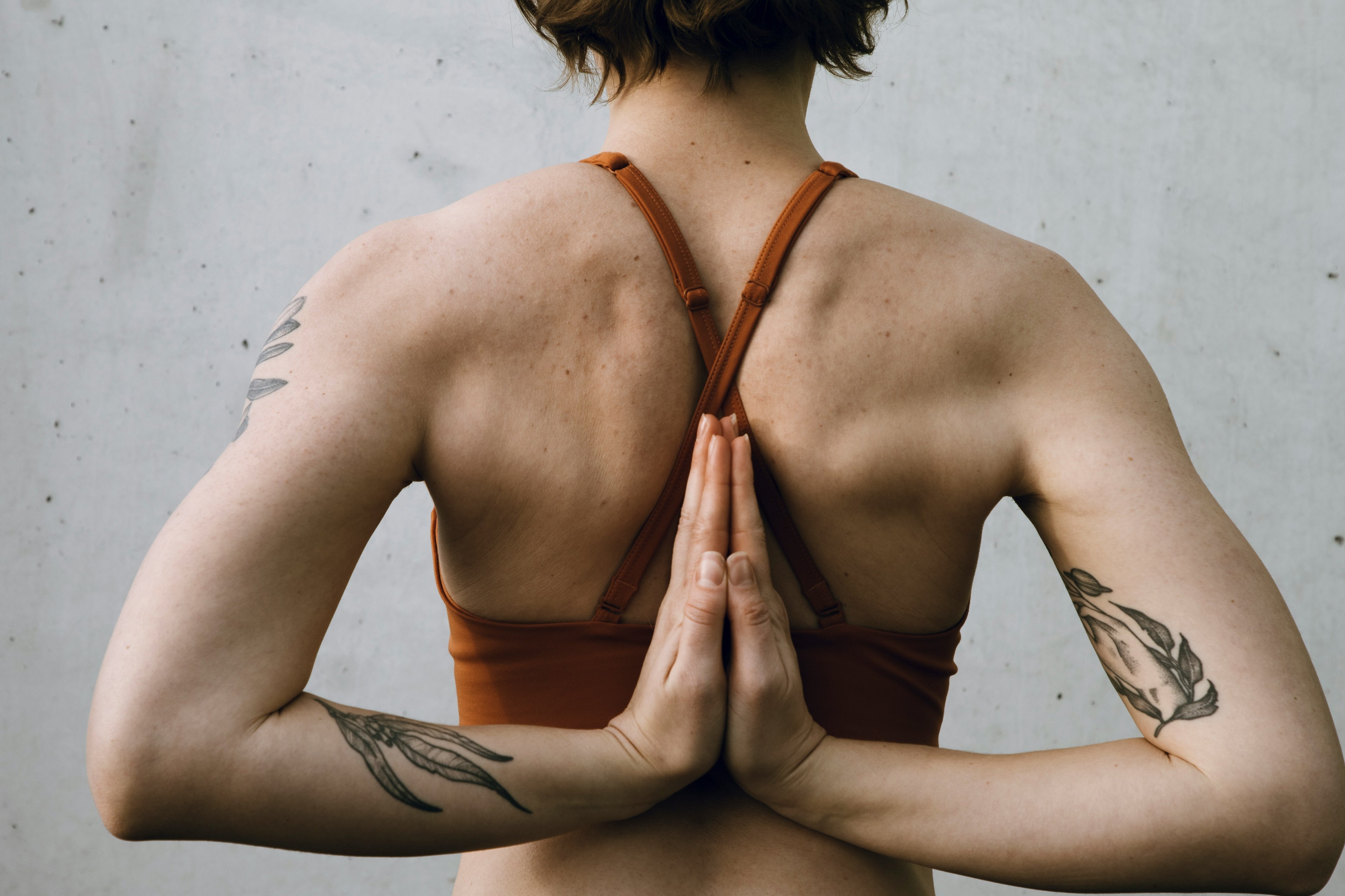 Are you mats recyclable in Australia? Yoga girl with her hands in prayer behind her back