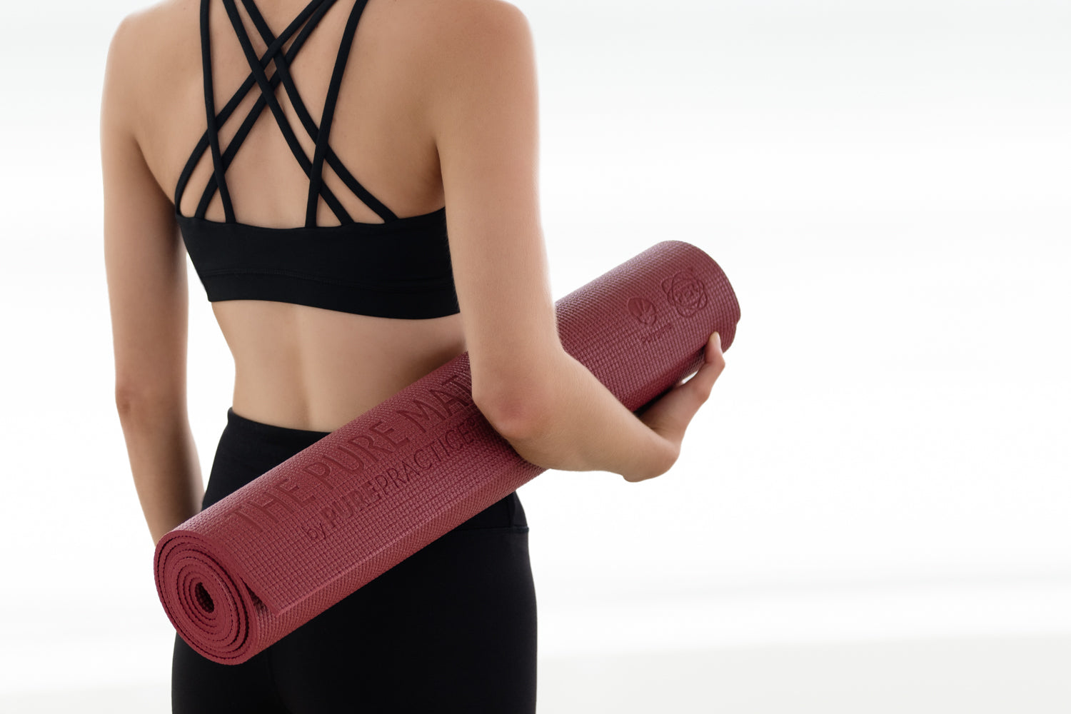 Best yoga mat material, woman holding a PER yoga mat