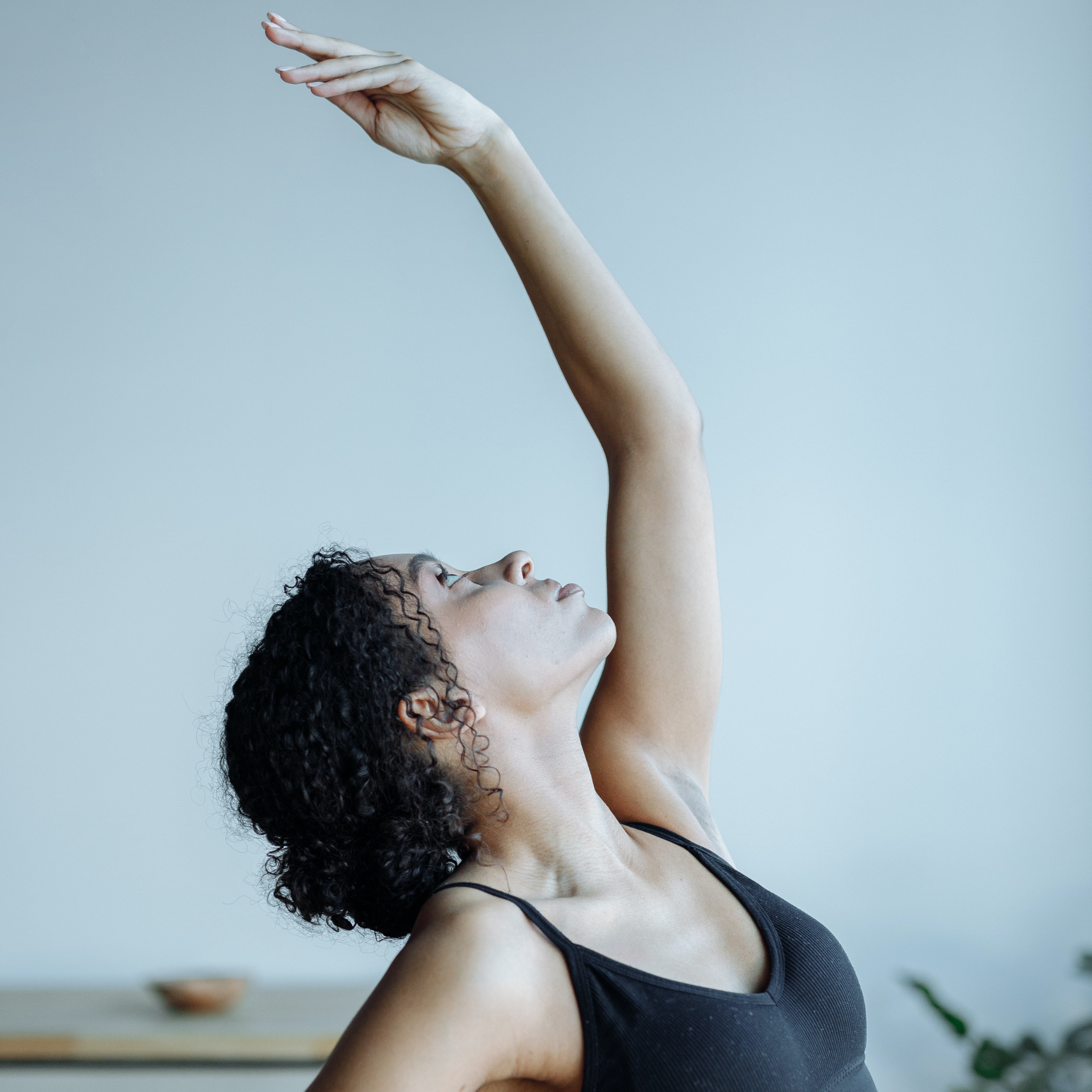 Graceful girl looking at her wrist in yoga